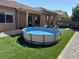 Backyard featuring an above-ground pool and artificial grass, ideal for outdoor fun at 4780 Lorenzo Way, Pahrump, NV 89061