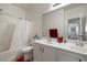 Clean bathroom with a double vanity, shower-tub combo, and ample storage space at 4780 Lorenzo Way, Pahrump, NV 89061
