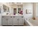 Bathroom featuring a soaking tub, double vanity, and bright lighting, creating a spa-like experience at 4780 Lorenzo Way, Pahrump, NV 89061