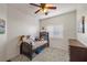 Cozy bedroom with a comfortable bed, ceiling fan, and ample natural light from the window at 4780 Lorenzo Way, Pahrump, NV 89061