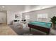 Bright game room with stylish sectional sofa, pool table, and neutral decor at 4780 Lorenzo Way, Pahrump, NV 89061