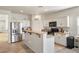 Well-lit kitchen featuring white cabinets, stainless steel appliances, and a breakfast bar at 4780 Lorenzo Way, Pahrump, NV 89061