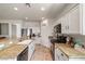 Bright kitchen with granite countertops, white cabinets, and black appliances at 4780 Lorenzo Way, Pahrump, NV 89061
