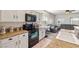 Granite countertops, white cabinetry and black appliances are the stars of this kitchen view at 4780 Lorenzo Way, Pahrump, NV 89061