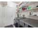 Well-lit laundry room with gray front-load machines and ample shelving for storage at 4780 Lorenzo Way, Pahrump, NV 89061