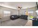 Bright living room featuring two sofas, plush carpet, and sliding glass door to the backyard at 4780 Lorenzo Way, Pahrump, NV 89061