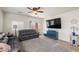 Cozy living room featuring a large TV, comfortable sofas, and access to the backyard patio at 4780 Lorenzo Way, Pahrump, NV 89061