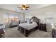 Inviting main bedroom featuring a large bed, ceiling fan, and bright windows, creating a relaxing atmosphere at 4780 Lorenzo Way, Pahrump, NV 89061