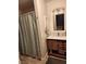 Bathroom with updated vanity, mirror, and a shower with a patterned curtain at 4805 S Torrey Pines Dr # 101, Las Vegas, NV 89103