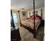 Primary bedroom with a four-poster bed and wood-look flooring at 4805 S Torrey Pines Dr # 101, Las Vegas, NV 89103