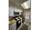 Cozy kitchen with white cabinetry, butcher block counters, and a modern stainless steel refrigerator at 4805 S Torrey Pines Dr # 101, Las Vegas, NV 89103