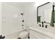Bathroom featuring a shower over tub, white vanity with sink, black hardware and green towel at 5078 Mountain Vista St, Las Vegas, NV 89120