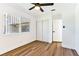 Bedroom featuring wood-look floors, closet, security bars on the window and a ceiling fan at 5078 Mountain Vista St, Las Vegas, NV 89120