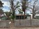 Photo of the home's backyard with mature trees, fencing, and potential for landscaping at 524 5Th St, Boulder City, NV 89005