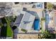 Aerial view of home featuring a pool, solar panels, and green turf yard at 5453 Yvonne Cir, Las Vegas, NV 89122