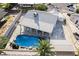 Aerial view of backyard pool with rock features, and solar panels on roof at 5453 Yvonne Cir, Las Vegas, NV 89122