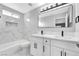 Modern bathroom with double sink vanity, large mirror, and marble-like tile at 5453 Yvonne Cir, Las Vegas, NV 89122
