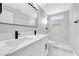 A renovated bathroom with marble shower, modern vanity, dual sinks, and matte black hardware at 5453 Yvonne Cir, Las Vegas, NV 89122