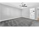 Spacious bedroom features plush carpet, modern ceiling fan, and closet with mirrored doors at 5453 Yvonne Cir, Las Vegas, NV 89122