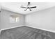 Bedroom with neutral walls, gray carpet and ceiling fan at 5453 Yvonne Cir, Las Vegas, NV 89122