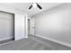 This bedroom features neutral paint, plush gray carpet, and a sliding door closet at 5453 Yvonne Cir, Las Vegas, NV 89122
