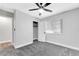This bedroom features neutral paint, plush gray carpet, ceiling fan, and closet at 5453 Yvonne Cir, Las Vegas, NV 89122