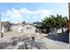 Inviting single-story home featuring gravel landscaping, mature tree, and a concrete driveway at 5453 Yvonne Cir, Las Vegas, NV 89122