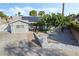 Inviting single-story home featuring desert landscaping, solar panels, and an extended driveway at 5453 Yvonne Cir, Las Vegas, NV 89122