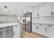 An open kitchen features new stainless steel appliances and white cabinets with dark hardware at 5453 Yvonne Cir, Las Vegas, NV 89122