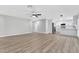 An open-concept living room featuring hardwood flooring, modern ceiling fan, and updated kitchen at 5453 Yvonne Cir, Las Vegas, NV 89122