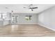 Spacious living room with hardwood flooring, modern ceiling fan, and view to the updated kitchen at 5453 Yvonne Cir, Las Vegas, NV 89122