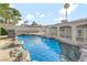 Sparkling pool with rock features and secure fencing in a private backyard oasis at 5453 Yvonne Cir, Las Vegas, NV 89122