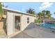 Pool house with gated entry located near the in-ground pool with rock waterfall feature at 5453 Yvonne Cir, Las Vegas, NV 89122
