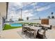 Backyard features a refreshing pool, string lights, and an outdoor dining area perfect for entertaining guests at 6301 Garwood Ave, Las Vegas, NV 89107