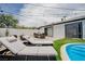 Outdoor living at its best with a pool, lounge chairs, and dining area, ready for summer fun at 6301 Garwood Ave, Las Vegas, NV 89107