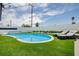 Lounge by the pool with a well-maintained patio with lounge chairs and turf at 6301 Garwood Ave, Las Vegas, NV 89107
