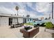 Relaxing backyard featuring a sparkling pool, comfortable lounge furniture, and an inviting outdoor dining area at 6301 Garwood Ave, Las Vegas, NV 89107
