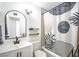 Modern bathroom with a tub, stylish vanity, decorative mirror, and contemporary shower curtain for a sleek look at 6301 Garwood Ave, Las Vegas, NV 89107