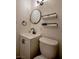 Well-lit half bathroom with a modern vanity, stylish mirror, and sleek black hardware accents at 6301 Garwood Ave, Las Vegas, NV 89107