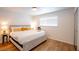 Bright bedroom with large window and a comfortable king-size bed featuring crisp white linens and decorative yellow pillows at 6301 Garwood Ave, Las Vegas, NV 89107