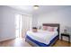 Bright bedroom with a plush king-size bed, stylish linens, and a sliding glass door providing access to outdoor space at 6301 Garwood Ave, Las Vegas, NV 89107