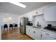 Updated kitchen with stainless steel appliances, white cabinets, and adjacent dining area at 6301 Garwood Ave, Las Vegas, NV 89107