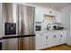 Close-up showcasing the stainless steel refrigerator and modern white cabinets of a well-equipped kitchen at 6301 Garwood Ave, Las Vegas, NV 89107