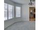 Bright living room with large windows and a glimpse into the adjacent kitchen at 6436 Deadwood Rd, Las Vegas, NV 89108