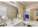 Bathroom featuring a vanity, mirror, and a bathtub-shower combo with a glass door at 6735 W Charleston Blvd # 4, Las Vegas, NV 89146