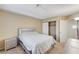 Neutral bedroom with carpet, a window, and a bed with a lighted headboard, closet, and nightstand at 6735 W Charleston Blvd # 4, Las Vegas, NV 89146