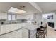Bright kitchen with marble countertops, white cabinetry, and a breakfast bar for casual dining at 6735 W Charleston Blvd # 4, Las Vegas, NV 89146