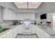Well-lit kitchen featuring white cabinets, marble countertops, and modern appliances for cooking at 6735 W Charleston Blvd # 4, Las Vegas, NV 89146