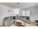 Cozy living room with two grey sofas, neutral carpet and plenty of natural light at 6735 W Charleston Blvd # 4, Las Vegas, NV 89146