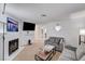 Open-concept living room with a fireplace, neutral carpet and a mounted television at 6735 W Charleston Blvd # 4, Las Vegas, NV 89146